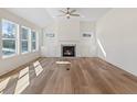 Sunlit living room with hardwood floors, fireplace, and built-in shelving at 212 Harvest Trl, Hiram, GA 30141