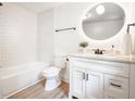 Bright bathroom featuring subway tiles, modern fixtures, and a stylish round mirror at 220 Hicks Se Dr, Marietta, GA 30060