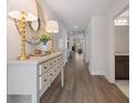 Long hallway with decorative table, modern lighting, and wood look flooring at 1341 Cedarcrest Blvd, Acworth, GA 30101