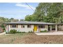 Charming ranch home with a yellow door and well-maintained lawn at 1625 Austin Dr, Decatur, GA 30032