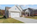 Gray and brick home with white accents, 2-car garage, and landscaping at 2760 Marie Way, Cumming, GA 30028