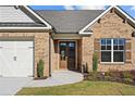 Front entrance with double doors and brick facade at 2780 Marie Way, Cumming, GA 30028