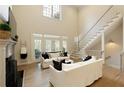 Elegant living room with high ceilings, fireplace, and plenty of natural light from large windows at 1950 Buford Dam Rd # 105, Cumming, GA 30041