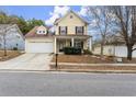 Two-story house with a two-car garage and front yard at 498 Anglewood Trce, Stockbridge, GA 30281