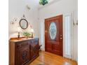 Bright and spacious entryway with hardwood floors and antique cabinet at 7420 Colony Ct, Cumming, GA 30041