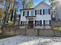 Two-story house with white siding, black shutters, and a wooden deck at 3385 Continental Dr, Cumming, GA 30041