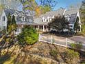 Beautiful two-story home with a white picket fence, mature landscaping, and a welcoming front porch at 220 Spring Branch Dr, Canton, GA 30115