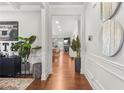 Bright hallway with hardwood floors, decorative wall art, and a view into the living area at 3210 Ancoats St, Douglasville, GA 30135