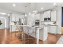 Modern kitchen with stainless steel appliances, a kitchen island, and stylish pendant lighting at 3210 Ancoats St, Douglasville, GA 30135