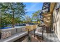 Private patio with outdoor seating and tennis court view at 10 Chaumont Nw Sq, Atlanta, GA 30327