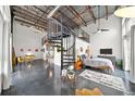 Contemporary living space with polished floors, spiral staircase, bedroom, and an open layout at 572 Edgewood Ne Ave # 306, Atlanta, GA 30312