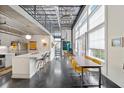 Sunlit living area with a spiral staircase, modern kitchen, dining area, and large windows at 572 Edgewood Ne Ave # 306, Atlanta, GA 30312