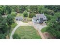 Aerial view of house with large backyard, detached garage, and long driveway at 695 Old Peachtree Rd, Lawrenceville, GA 30043