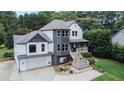 Exterior of a two-story house with gray and white siding, a large garage, and a deck at 695 Old Peachtree Rd, Lawrenceville, GA 30043