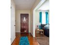 Inviting entryway featuring a wooden front door, hardwood floors, and a glimpse of the living room at 1236 Country Pine Dr, Ellenwood, GA 30294