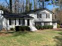 Bright two-story house with black shutters, manicured landscaping, and a walkway to the front door at 1236 Country Pine Dr, Ellenwood, GA 30294
