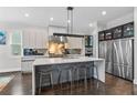 Bright kitchen features stainless steel appliances, a large island with seating and stone backsplash at 2941 Lookout Ne Pl, Atlanta, GA 30305