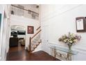 Bright foyer with hardwood floors, staircase, and view of the living room at 210 Huiet Dr, Mcdonough, GA 30252