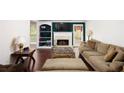 Inviting living room features fireplace, built-in shelves, and wood flooring at 210 Huiet Dr, Mcdonough, GA 30252