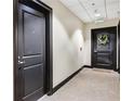 Hallway featuring carpet and apartment doors, creating a well-maintained and inviting atmosphere for residents at 285 Centennial Olympic Park Nw Dr # 903, Atlanta, GA 30313
