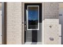 Modern dark gray front door with glass panels and keyless entry at 214 Wilder Ridge Way, Lawrenceville, GA 30044
