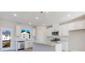 Spacious kitchen with white cabinets, granite countertops, and stainless steel appliances at 214 Wilder Ridge Way, Lawrenceville, GA 30044