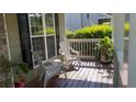 Inviting front porch with comfortable seating, plants, and natural light at 815 Sylvan Dr, Marietta, GA 30066