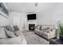 Comfortable living room featuring a fireplace, neutral decor, and plenty of seating at 6427 Grey Fox Way, Riverdale, GA 30296