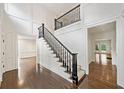 Elegant foyer with hardwood floors, paneled walls, and staircase with black railings at 420 Argonne Nw Dr, Atlanta, GA 30305