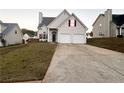 Attractive home with a two-car garage, well-kept lawn, and a long driveway at 137 St Ann Cir, Dallas, GA 30157