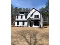 Two-story home featuring white vertical siding, a covered porch, and a dark gray roof at 3745 Pilgrim Mill Rd, Cumming, GA 30041