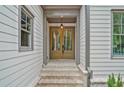 Elegant front entry featuring double doors, brick steps, and classic sidelights at 3780 Tamiami Trl, Cumming, GA 30041