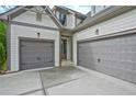 Spacious three car garage with gray doors, attached to the main house at 3780 Tamiami Trl, Cumming, GA 30041