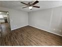 Open living room featuring new hardwood flooring and modern ceiling fan at 6500 Wellington Chase Ct, Lithonia, GA 30058