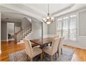 Elegant dining room with hardwood floors, chandelier, and a built-in bench at 4096 Oberon Se Ct, Smyrna, GA 30080