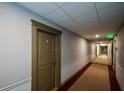 Well-lit hallway with neutral-colored walls and carpeting, leading to various units within the building at 3060 Pharr N Ct # 313, Atlanta, GA 30305