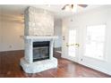 Stone fireplace in the living room with hardwood floors at 2068 Lakewood Cir, Grayson, GA 30017