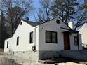 Side view of a home with a white exterior, black framed windows and driveway at 951 Lawton Sw St, Atlanta, GA 30310