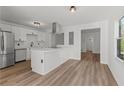 Bright kitchen with stainless steel appliances, white cabinets and eat-in island at 951 Lawton Sw St, Atlanta, GA 30310