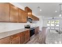 Modern kitchen with stainless steel appliances, granite counters, and stylish wood cabinets at 3269 Durston Ct, Dacula, GA 30019