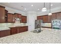 This kitchen features granite countertops, stainless steel appliances, and a center island at 2420 Bronze Ct, Cumming, GA 30041