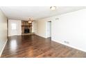 Spacious living room with a stone fireplace and wood-look flooring at 407 Robins Nest Ct, Woodstock, GA 30189