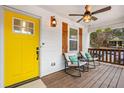 Welcoming front porch with rocking chairs, ceiling fan, and a vibrant yellow door at 1375 Miller Reed Se Ave, Atlanta, GA 30315