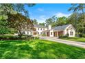 Beautiful home featuring a well-manicured lawn, mature trees, and a three-car garage, offering a perfect blend of elegance at 3488 Tuxedo Nw Rd, Atlanta, GA 30305