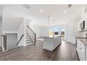 Open-concept kitchen features a granite island, stainless appliances, and seamless integration with living spaces at 3267 Durston Ct, Dacula, GA 30019