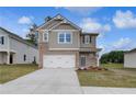 Beautiful two-story home with a well-manicured lawn and a two-car garage at 16 Camellia Dr, Fairburn, GA 30213