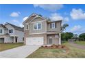 Attractive two-story home featuring a brick and siding exterior with a two-car garage at 16 Camellia Dr, Fairburn, GA 30213