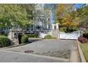 View of community entrance showcasing cobblestone drive, stone pillars, and building facade at 4100 Paces Se Walk # 1306, Atlanta, GA 30339