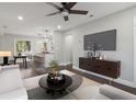 Bright, open living room with ceiling fan, modern furniture, and seamless flow to the kitchen at 2349 Springdale Sw Rd, Atlanta, GA 30315