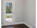 A white door leads to the outside with hardwood floors inside the home at 3102-A Brownstone Se Ln, Atlanta, GA 30354